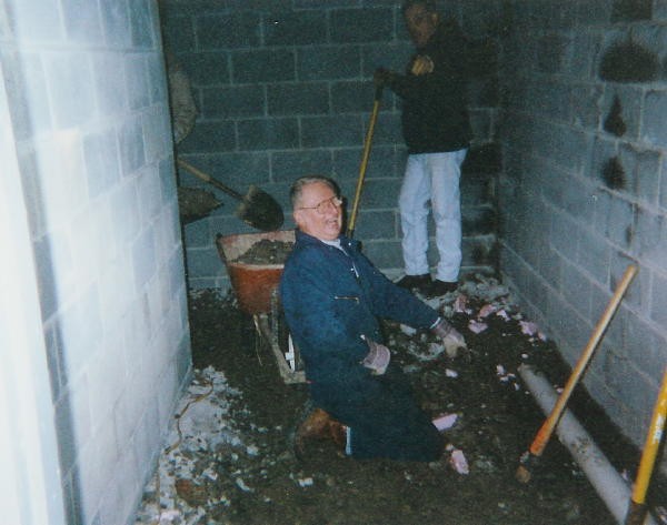 Jim Herr, probably prior to another injury, working on a drain line in the hallway of the new addition in 1999.