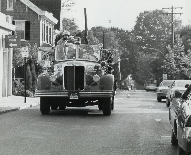 Larry Kirk and Glenn Teeter laying a supplying down Locust Street at a Ware drill.