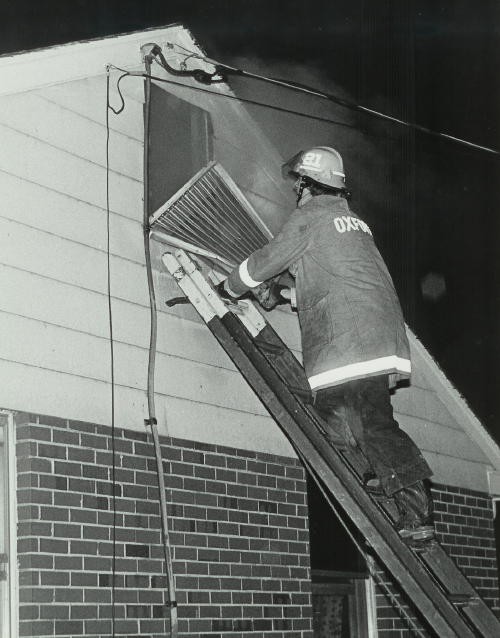 Firefighter Mike Nelson venting an attic at a house fire on Route 926 in Cochranville.