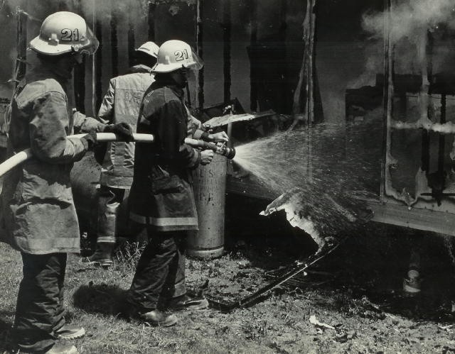 Mopping up a mobile home fire.