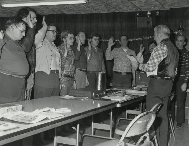 President Willard Ayers swearing in new Officers (1979):  (L-R): Paul Slauch, Tom McFadien, Harry Keith, Ed Holbrook, Harvey Poff, Ed Dudkewitcz, Rich Terry, Larry Groseclose, and Bob Brown.