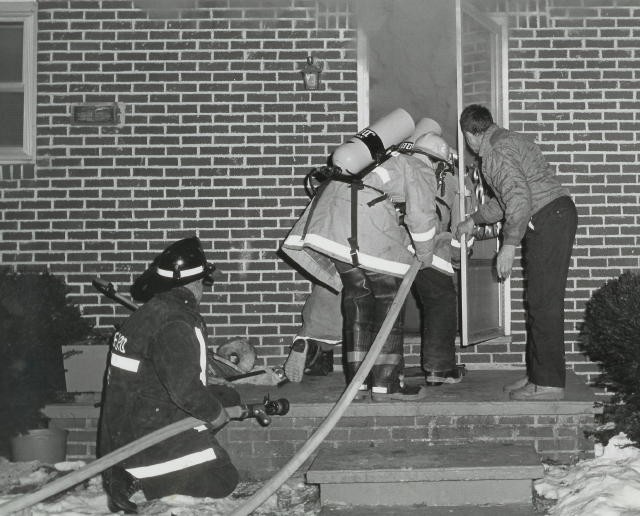 Crews making entry on House Fire on Reisler Road in Elk Township in 1978.