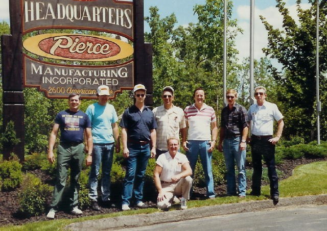 Pierce Manufacturing trip for Ladder 21 in 1989.  (L-R) &quot;Rocky&quot;, Mike Evosirch, Allen Fowler, Rich Terry, Frank Moroney, Percy Reynolds, and bus driver, Scott Wisner.  Jim Herr takes a knee in the front row.