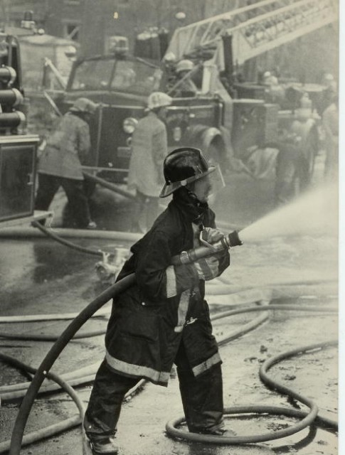 Rising Sun Firefighter Danny Alley operating a hand line at a fire.