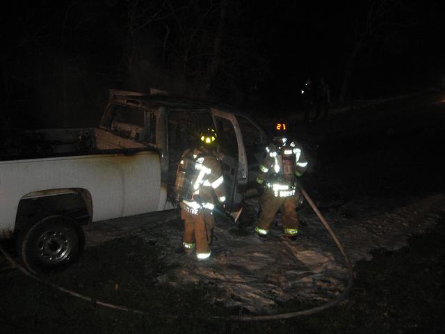 Firefighter Steven Brown and Hosman Matt Groseclose mopping up a truck fire on Barren Road.