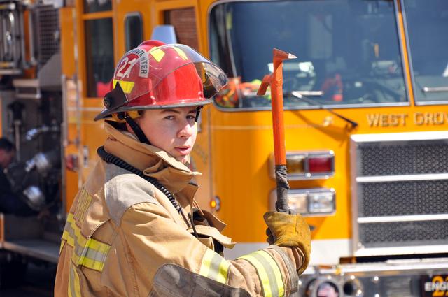 Junior Firefighter Brendan McNair posing at the South Third Street building fire.