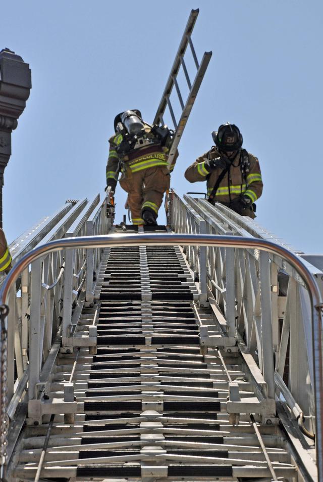 Firefighter Mark Groseclose goes to the roof.