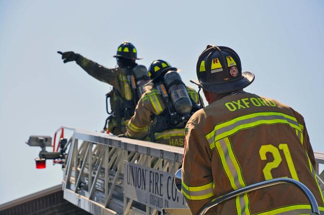 Firefighters Vince Brown and Alan Hastings spotting the aerial for Operator Rich Terry.