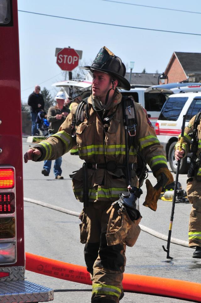 Firefighter Stephen Brown reaching for a tool on Engine 1.