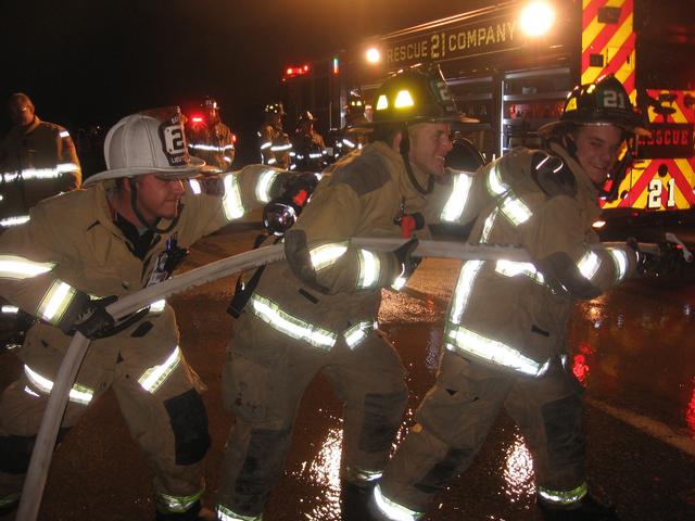 Lieutenant Bill Hensel assisting Firefighters Steven Brown and Dakota Brown with a handline at a crash on Route 1.