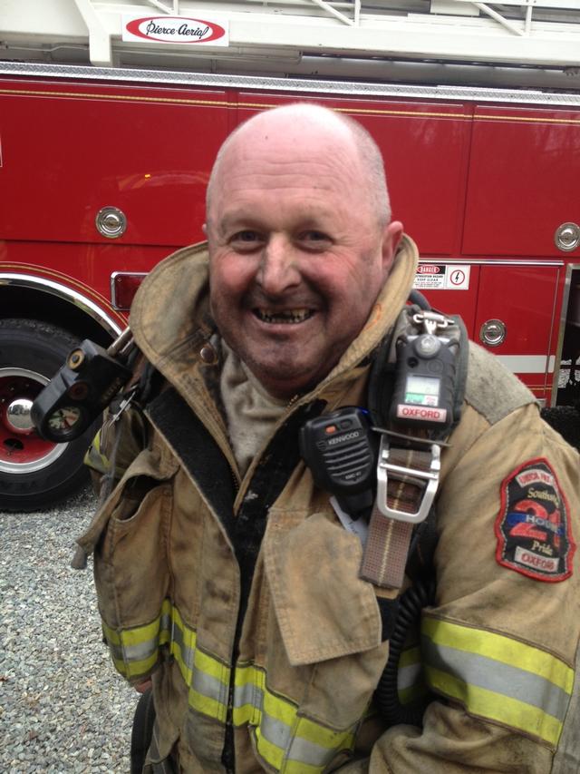 Firefighter Rick Ruoss wearing the results of working above a chimney on Route 896.